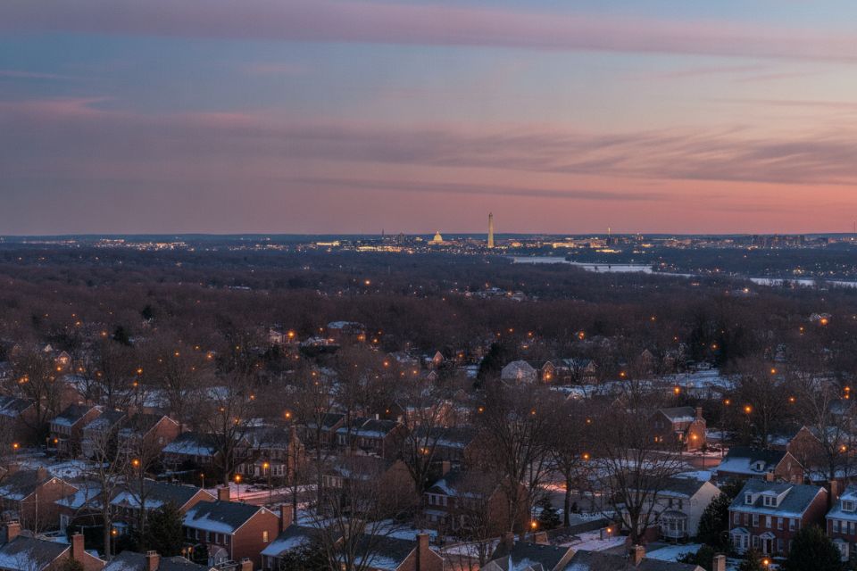 Suburban rooftops at dusk with the Washington skyline and the Washington Monument in the distance.