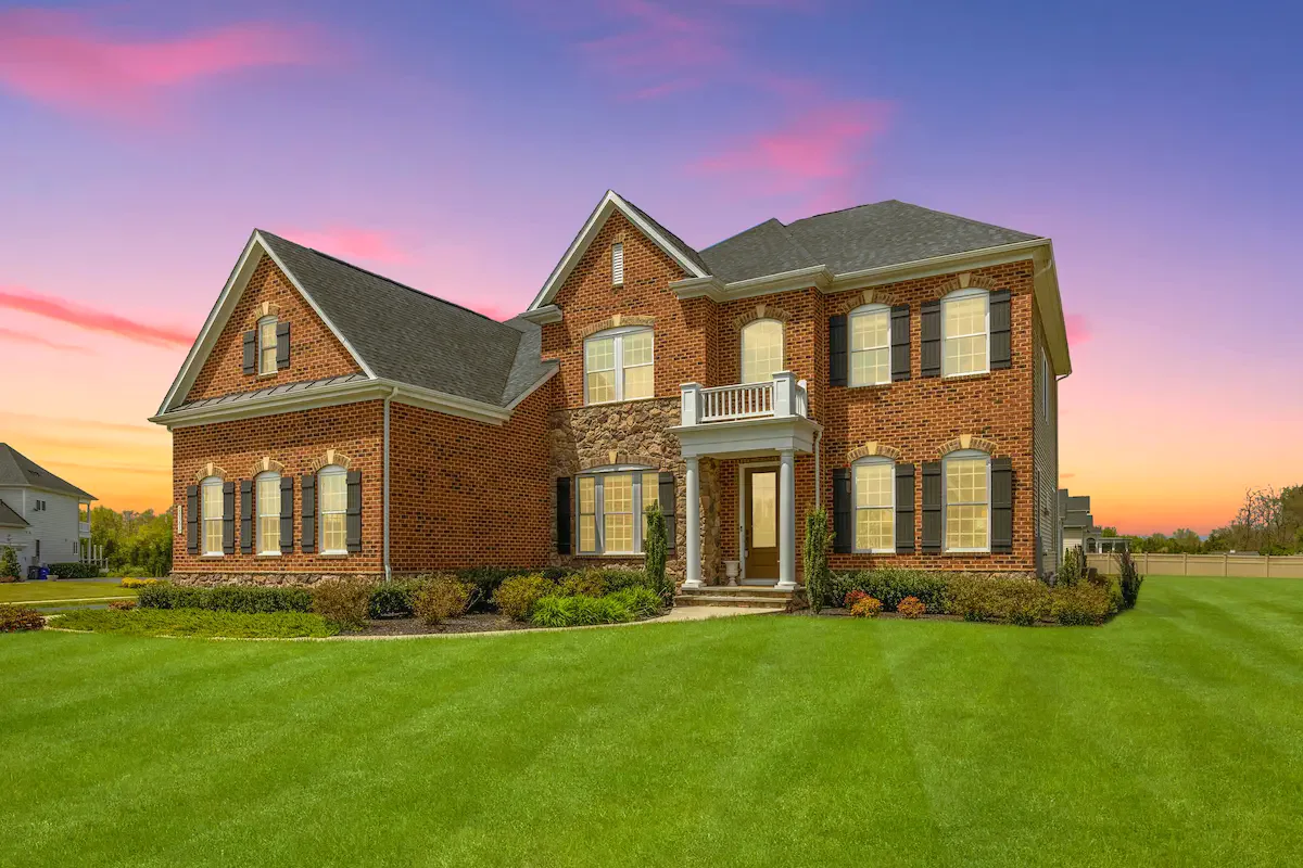 A brick colonial in Northern Virginia at sunset.
